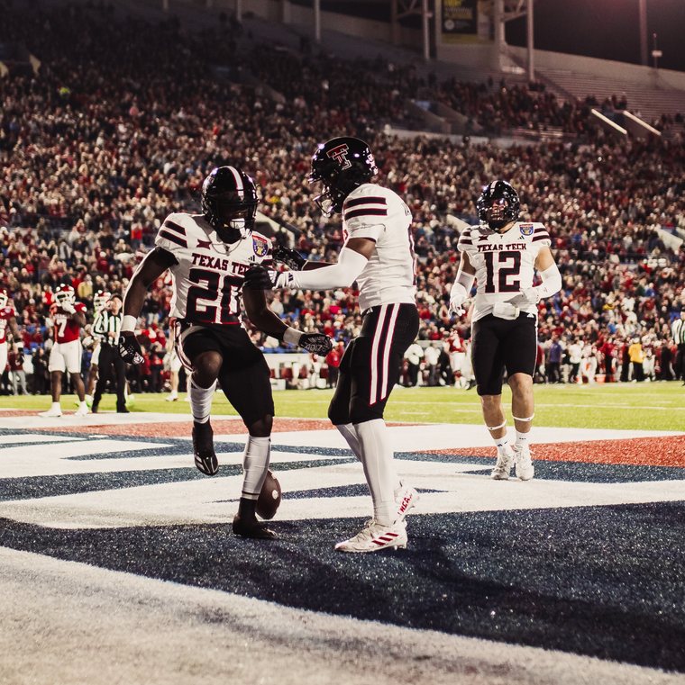 Texas Tech football players celebrating in the end zone